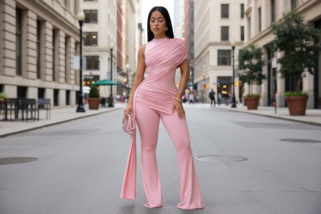Women's casual jumpsuit with crew neck, pleated ribbon details, and flare pants by Plush Fashion Hub, shown on a model.
