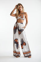 Women's feather print crop top and pants set by Plush Fashion Hub, casualwear 2-piece vacation outfit, stylish and comfortable.