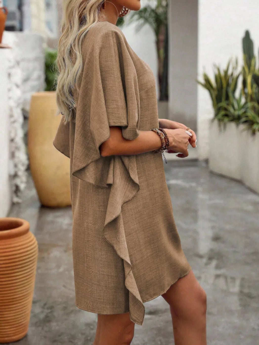 Women's flowy V-neck casual mini dress with ruffled sleeves, stylish and comfortable, made by Trendsi.