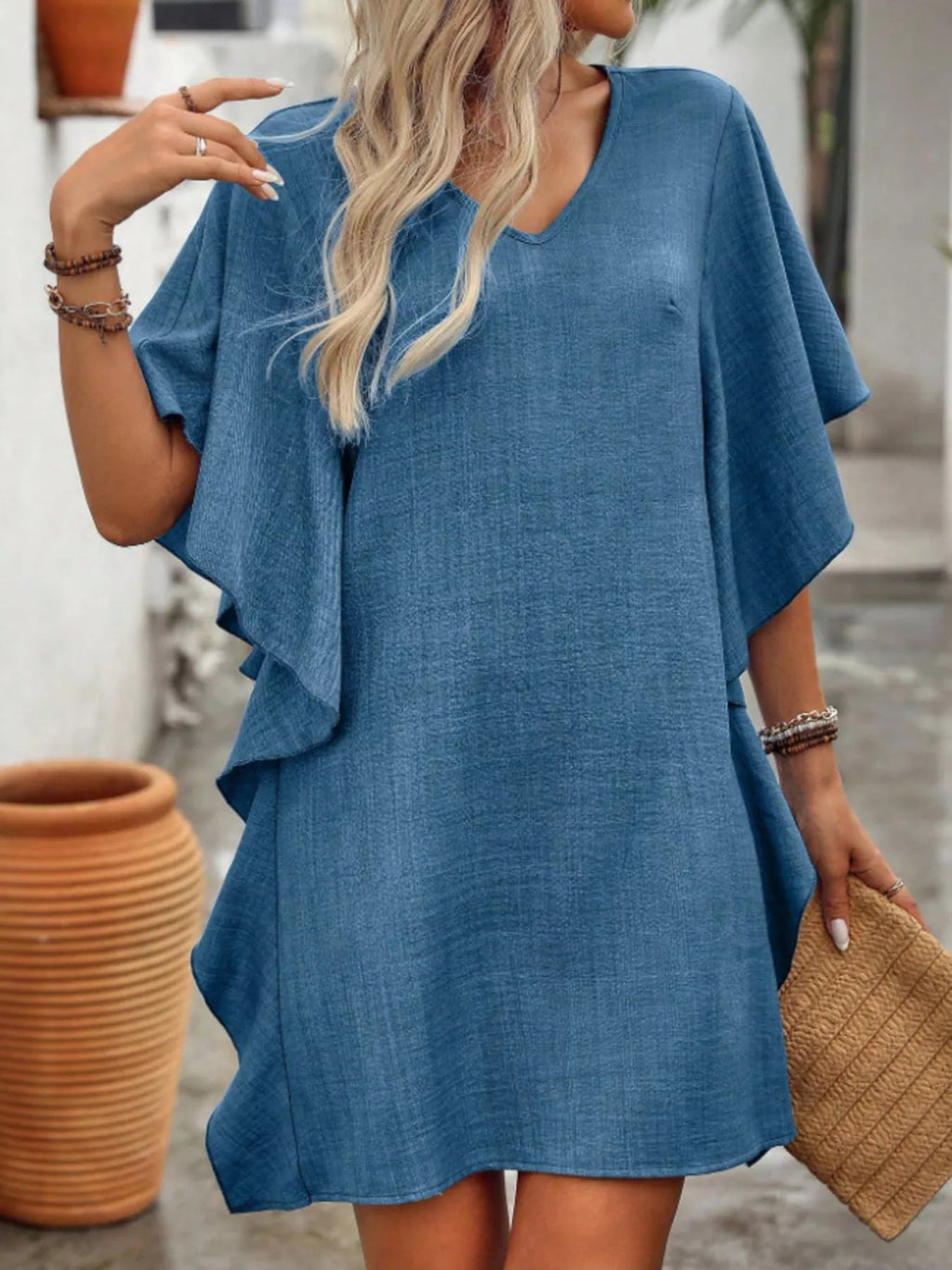 Women's flowy V-neck casual mini dress with ruffled sleeves, stylish and comfortable from Trendsi.