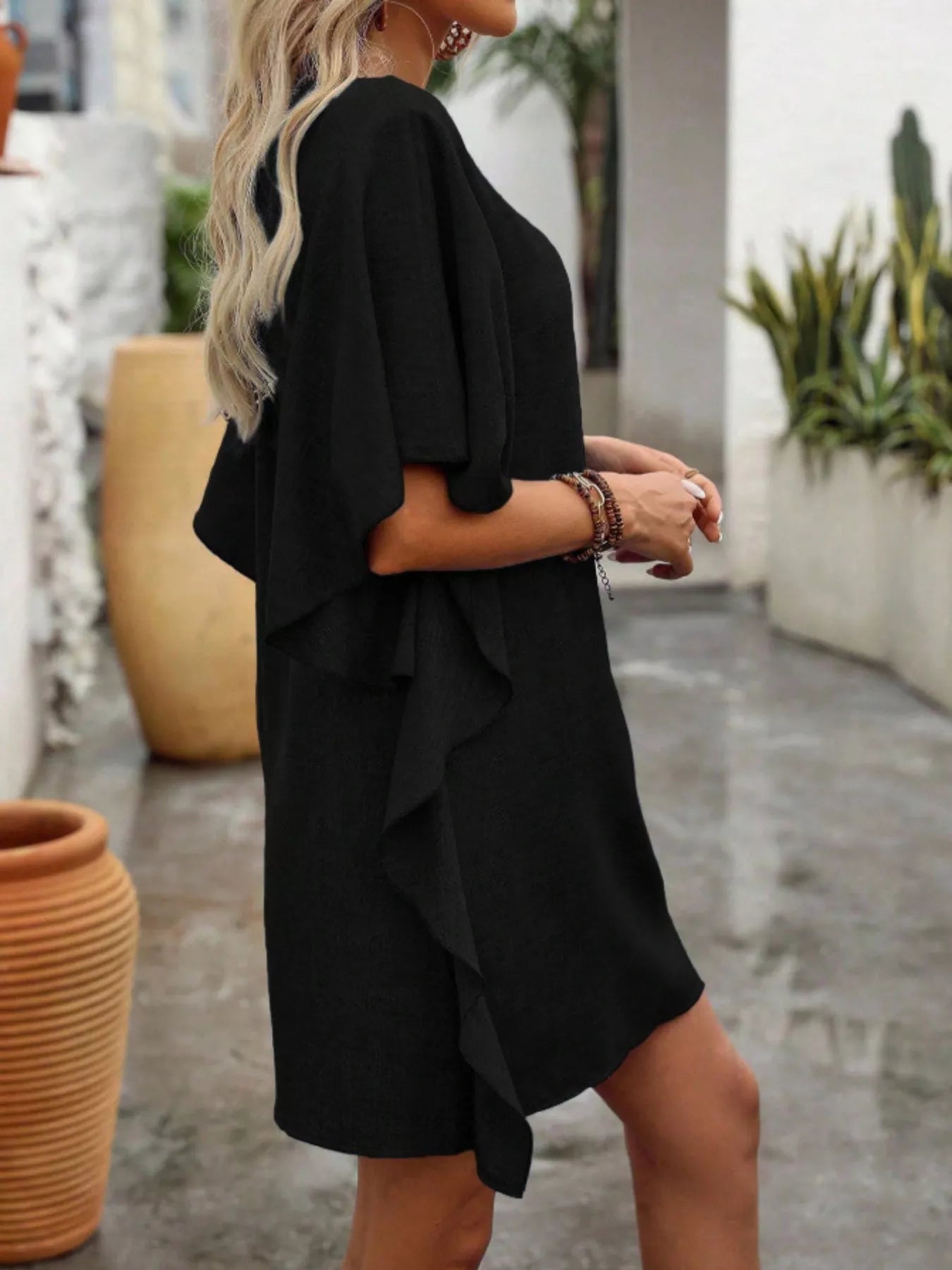 Women's flowy V-neck casual mini dress with ruffled sleeves, trendy and comfortable for summer wear.