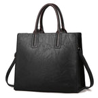 Women's handbag by Plush Fashion Hub featuring a stylish design with leather accents and a shoulder strap.