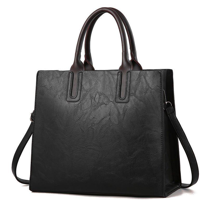 Women's handbag by Plush Fashion Hub featuring a stylish design with leather accents and a shoulder strap.