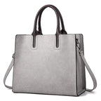 Leather women's handbag by Plush Fashion Hub with gold hardware and adjustable strap, stylish and versatile accessory.