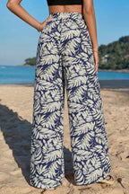 Women's high-waist leaf print wide-leg pants made of comfy cotton blend, featuring a casual, relaxed fit and stylish design.