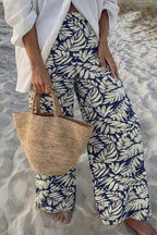 Women's high-waist leaf print wide-leg pants made from soft cotton blend, casual and comfortable for everyday wear.