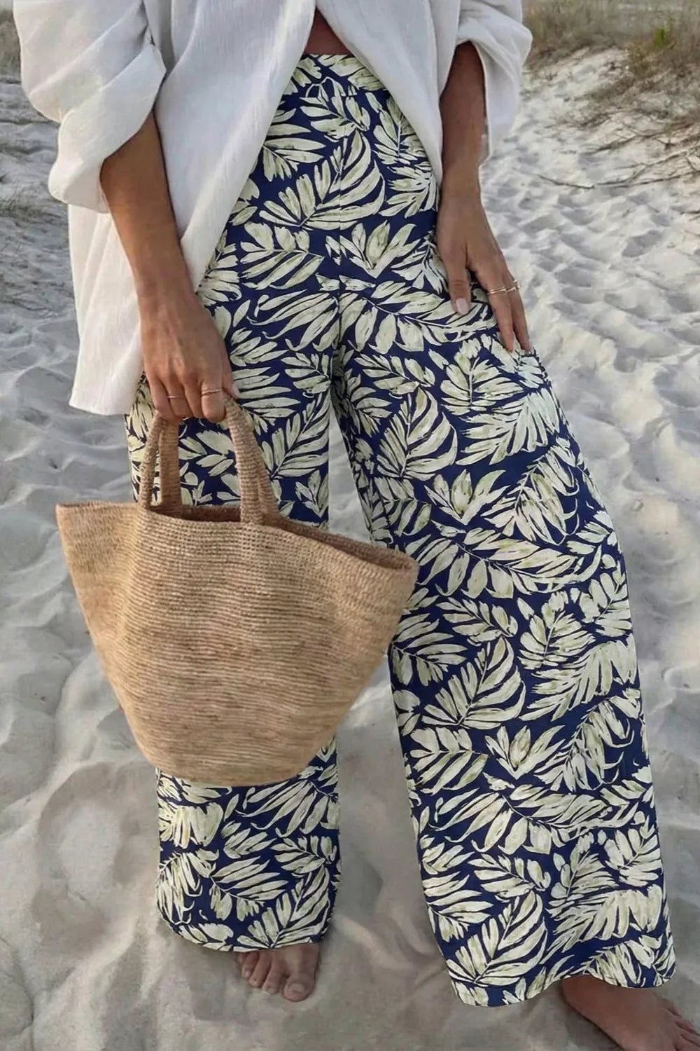 Women's high-waist leaf print wide-leg pants made from soft cotton blend, casual and comfortable for everyday wear.