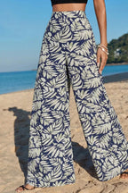 Women's high-waist leaf print wide-leg pants made of soft cotton blend, featuring a relaxed fit and casual style.