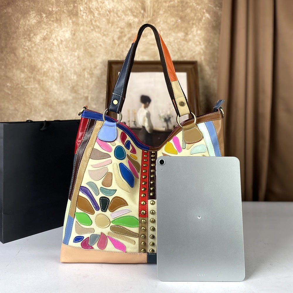 Large genuine leather women's crossbody bag with nautical-style design, featuring spacious compartments and adjustable strap.
