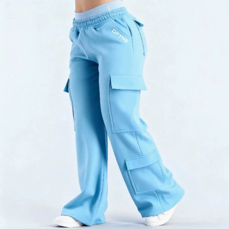 Women's loose-fit casual pants with pockets, solid color, two-tone design, by Plush Fashion Hub, shown on a model.