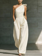 Women's loose sleeveless off-shoulder belt jumpsuit with wide-leg design, casualwear by Plush Fashion Hub, shown on a model.
