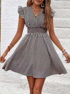 Women's striped V-neck mini dress with flutter sleeves, casual summer dress by Plush Fashion Hub, ideal for warm-weather styling.
