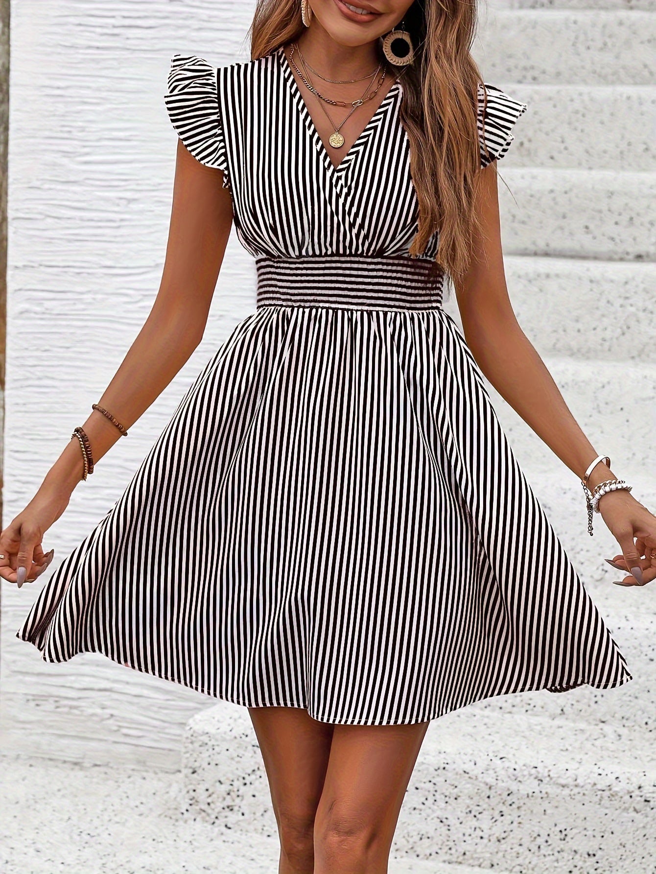 Women's striped V-neck mini dress with flutter sleeves, casual summer dress by Plush Fashion Hub, ideal for warm-weather styling.