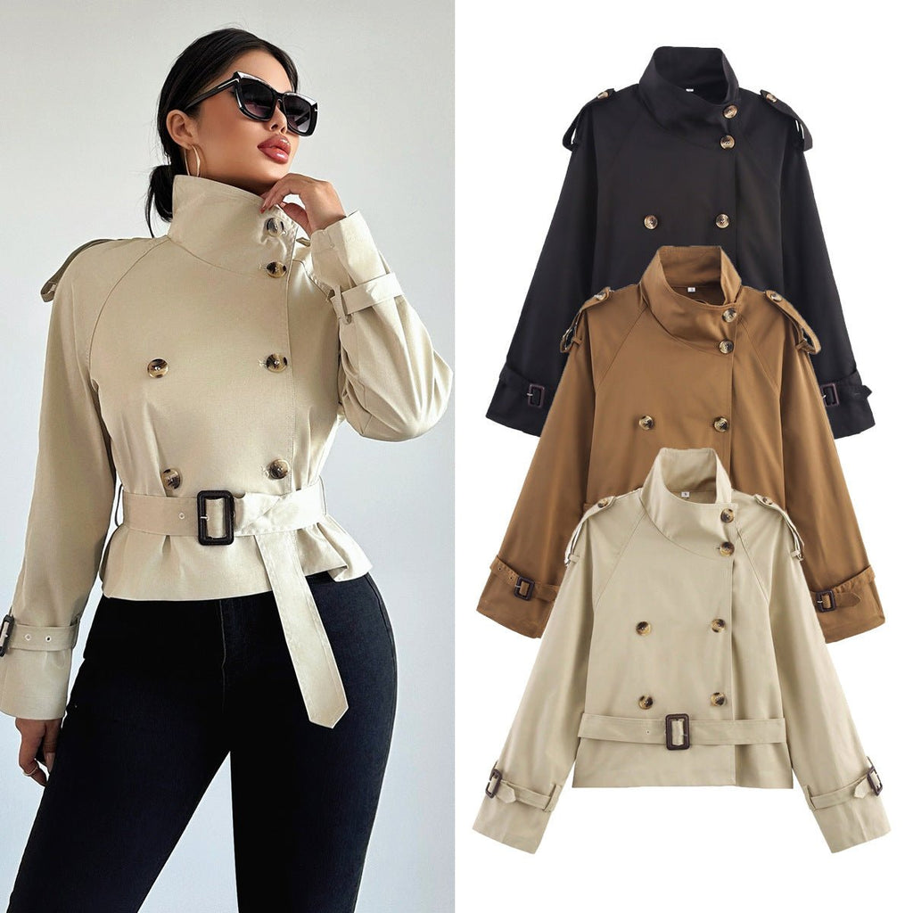 Women's short trench coat with notch collar and belt buckle detail, stylish jacket by Plush Fashion Hub.