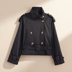 Women's short trench coat with notch collar and belt buckle detail by Plush Fashion Hub, shown in a stylish outerwear design.