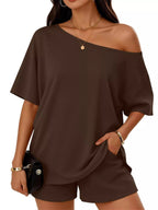 Plus size women's boat neck T-shirt and shorts lounge set by Trendsi, casual and comfortable clothing set for relaxed wear.