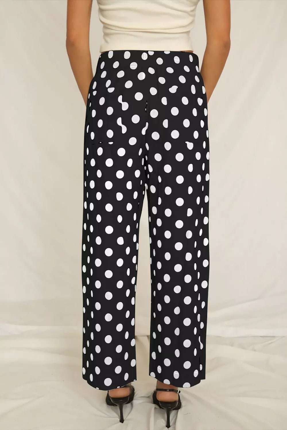 Women's polka dot straight-leg pants with pockets from Plush Fashion Hub, featuring a comfortable fit and classic pattern.