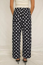 Women's polka dot straight-leg pants with pockets from Plush Fashion Hub, featuring a comfortable fit and classic pattern.
