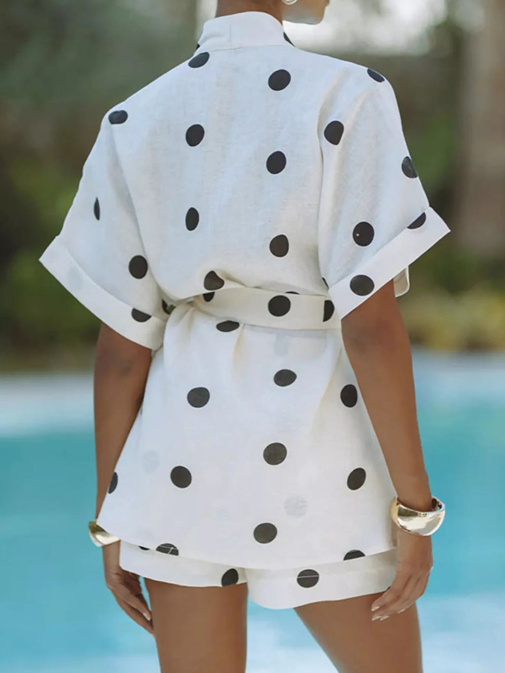 Women's polka dot tie waist top and shorts set, casual two-piece outfit by Trendsi, shown on a model with a relaxed summer style.