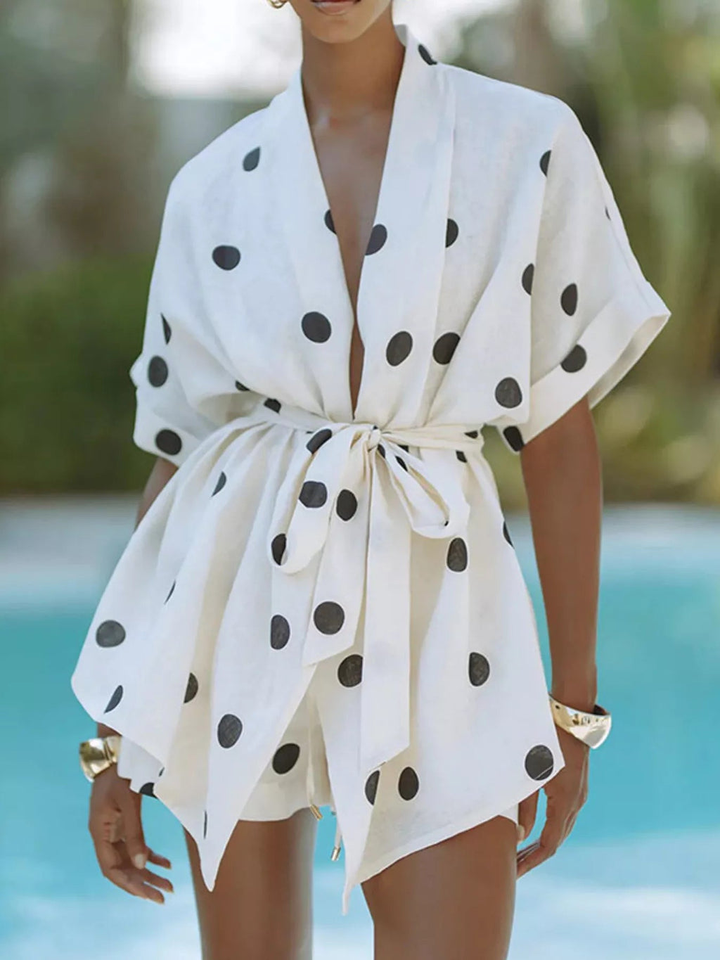 Women's polka dot tie waist top and shorts set, casual two-piece outfit by Trendsi, shown with the top and shorts styled together.