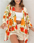 Women’s printed cardigan top with drop shoulder sleeves, casualwear by Plush Fashion Hub, featuring colorful floral print and soft fabric.