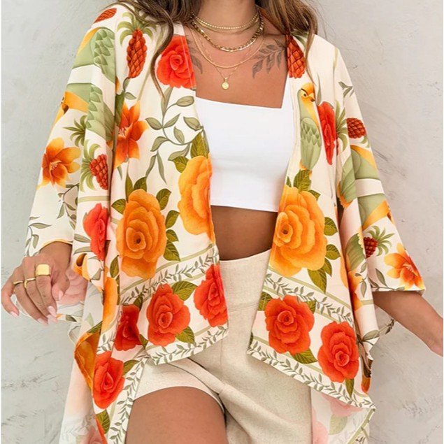 Women’s printed cardigan top with drop shoulder sleeves, casualwear by Plush Fashion Hub, shown on a model.
