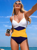 Women's ruffled color block one-piece swimsuit by Trendsi, stylish swimwear with ruffled details and vibrant color blocking.