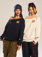 Women’s slanted shoulder embroidered long-sleeve casual top by Plush Fashion Hub, featuring intricate embroidery and a stylish design.