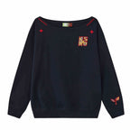 Women’s slanted shoulder embroidered long-sleeve casual top by Plush Fashion Hub, featuring intricate embroidery and a stylish design.