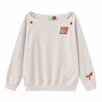 Women’s slanted shoulder embroidered long-sleeve casual top by Plush Fashion Hub, featuring intricate embroidery and a stylish design.