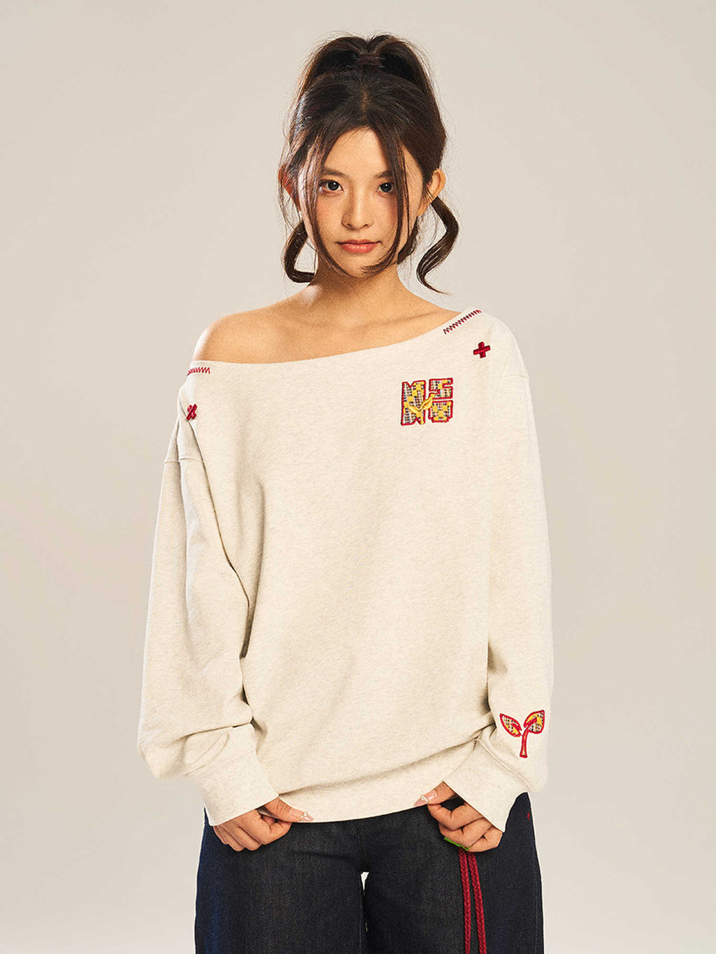 Women’s slanted shoulder embroidered long-sleeve casual top by Plush Fashion Hub showing intricate embroidery and stylish shoulder design.