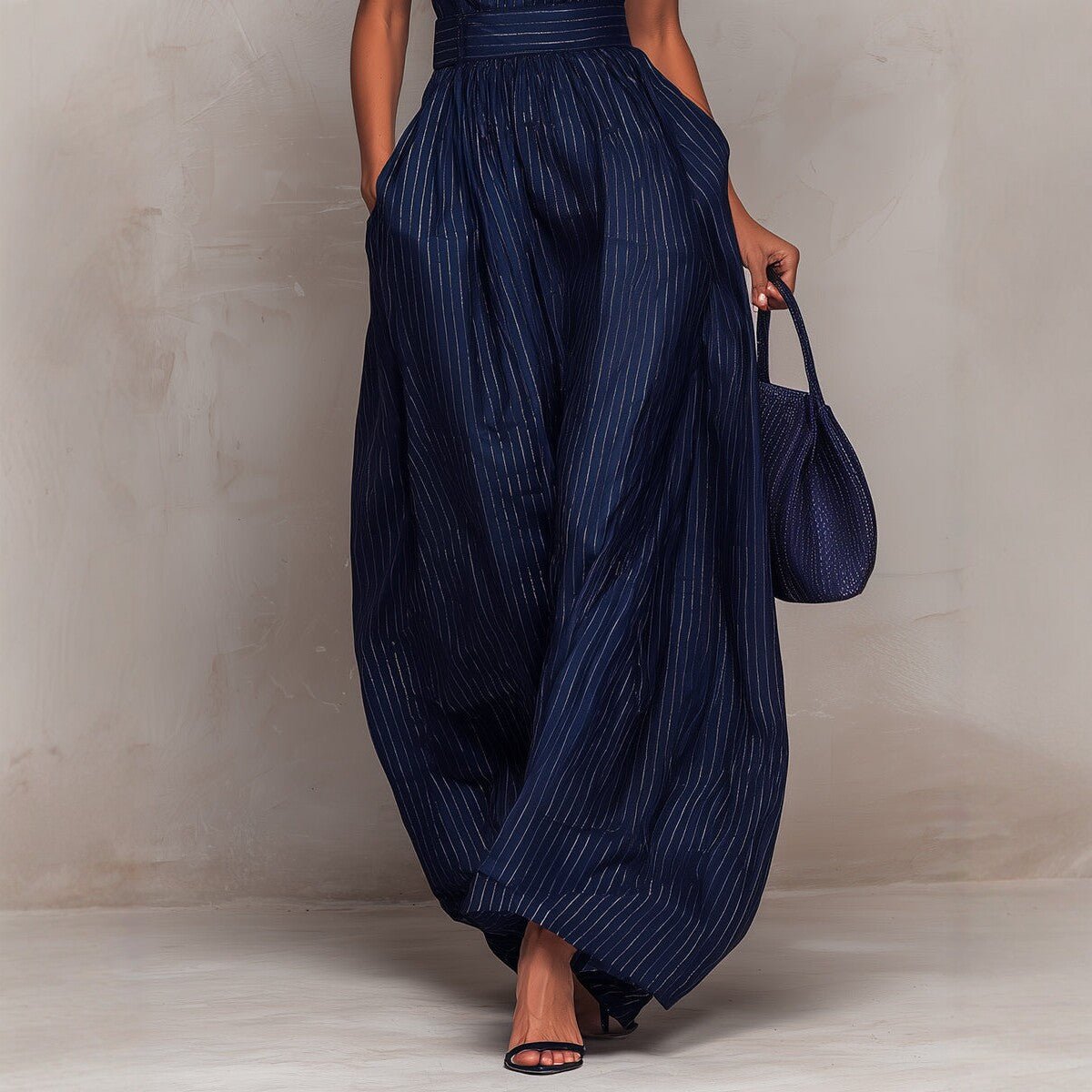 Women's sleeveless striped wide-leg jumpsuit with pockets, casualwear by Plush Fashion Hub, shown hanging on a clothing rack.