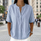 Women's solid color loose-fit short-sleeve pullover top by Plush Fashion Hub, casualwear, displayed on a model with a relaxed fit.