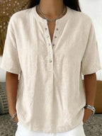 Women’s solid color loose-fit short-sleeve pullover top by Plush Fashion Hub, casualwear style, displayed on a model.