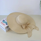 Women’s summer straw hat with wide brim and adjustable band, stylish hat from Plush Fashion Hub for sun protection and fashion.