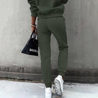 Women’s two-piece solid color hooded sweatshirt set by Plush Fashion Hub, casualwear with a cozy hooded top and matching pants.