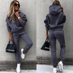 Women's two-piece solid color hooded sweatshirt set by Plush Fashion Hub, featuring a casual, comfortable matching top and pants ensemble.