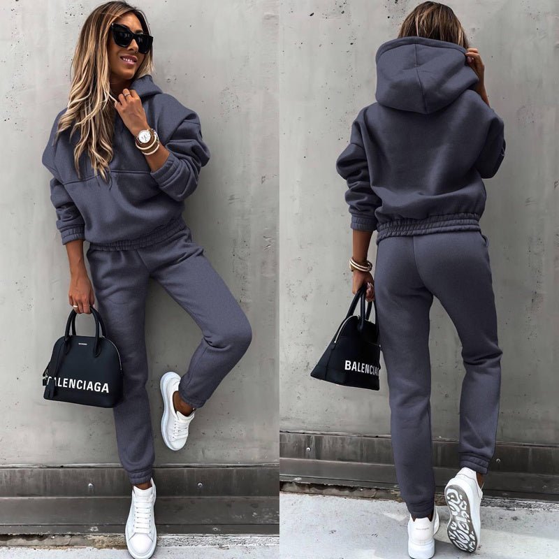 Women's two-piece solid color hooded sweatshirt set by Plush Fashion Hub, featuring a casual, comfortable matching top and pants ensemble.