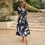 Women’s summer floral V-neck dress by Dukun Design featuring a flowy fabric and vibrant floral print.